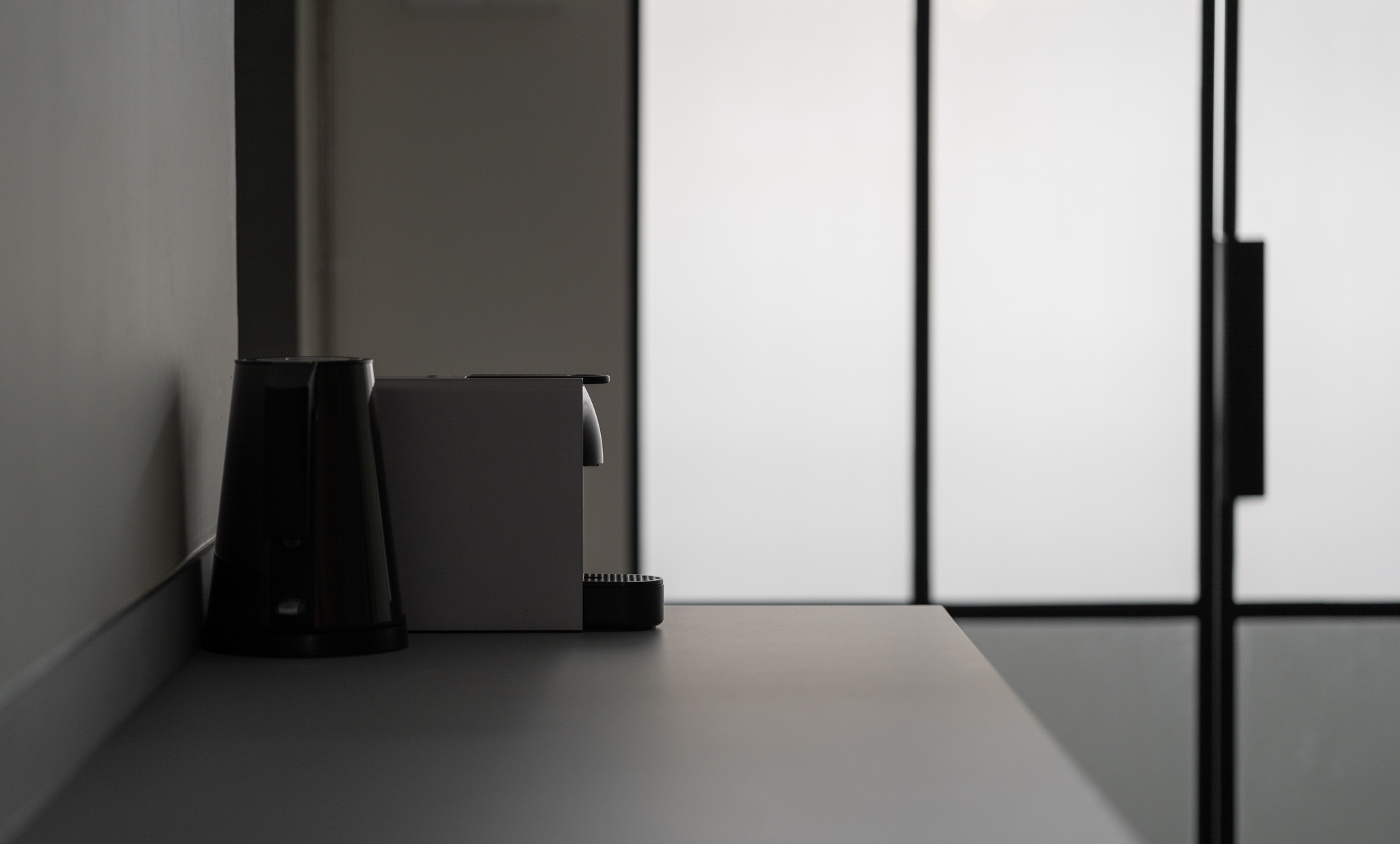Minimalist Home Kitchen design by Arche Interior; showing small coffee maker on the countertop